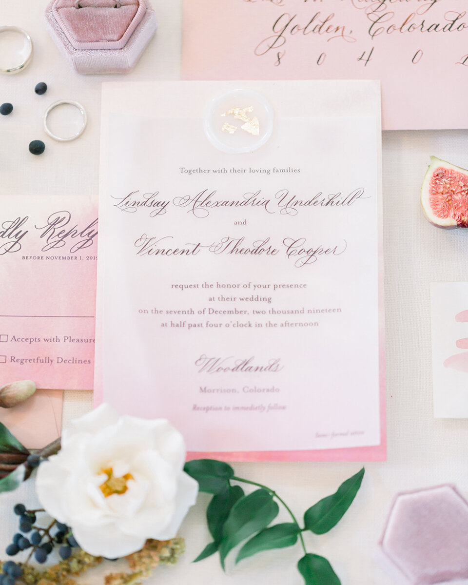 A vellum overlay can be used as the invitation card and adhered to a custom watercolor card with a wax seal.